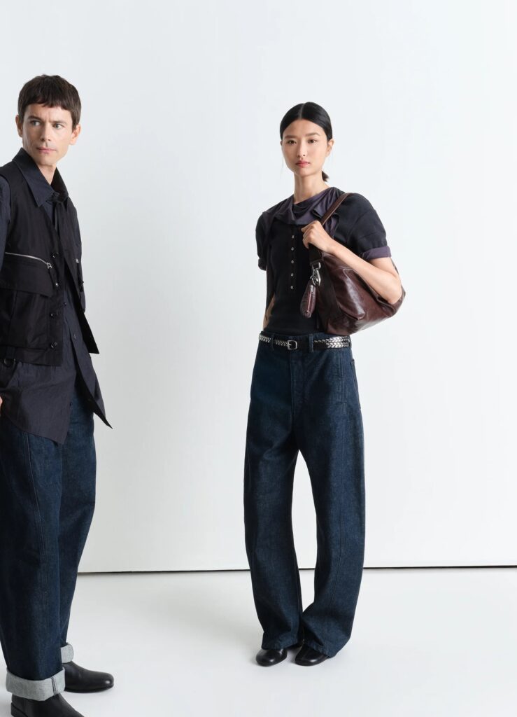 Lemaire SS25 collection showcasing minimalist fashion with high-waisted indigo jeans, a black top, and utility-inspired designs.