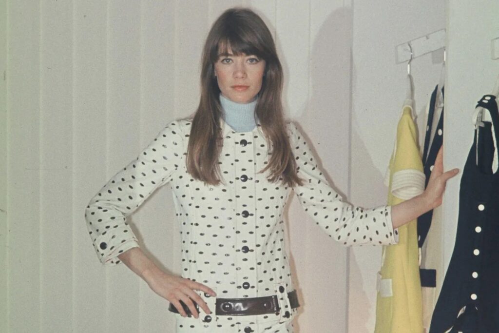 Françoise Hardy wearing a trapeze-cut coat by Courrèges, showcasing the timeless elegance of the French fashion house.