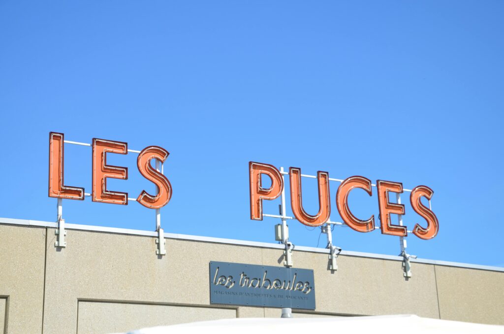Neon sign for Les Puces de Saint-Ouen, the largest antique market in Paris.