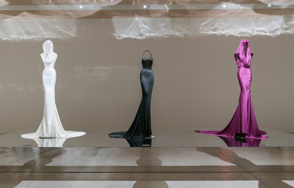 A lineup of Alaïa gowns on display at SCAD FASH Museum.
