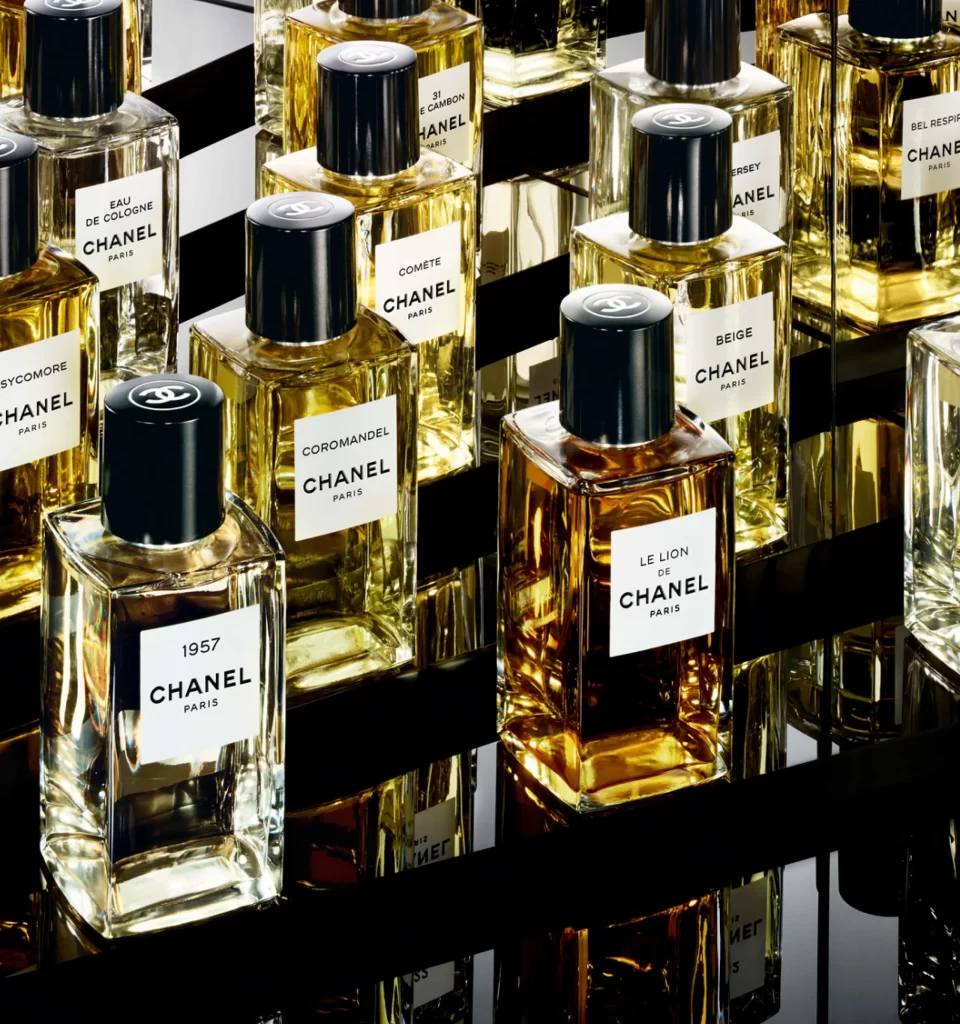 A selection of Chanel Les Exclusifs perfume bottles displayed on a sleek reflective surface. French fashion brands. french perfume shops in paris