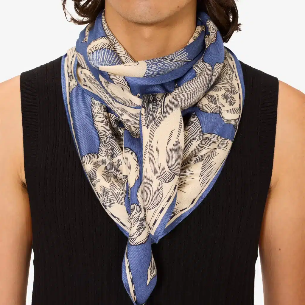 A navy blue silk scarf featuring an intricate astrology-themed print by Inoui Editions.