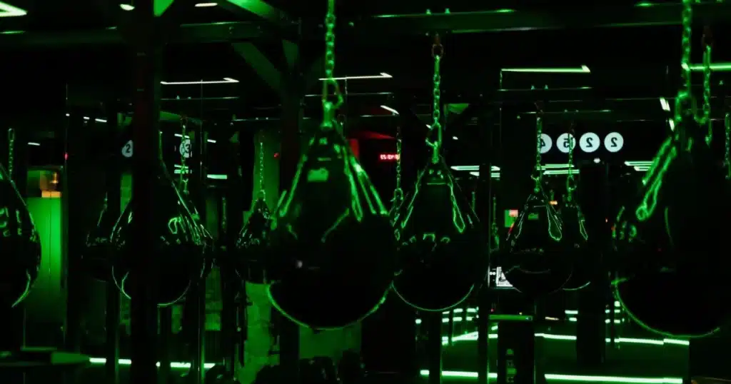 Aqua punching bags under neon lights at OUTBOXE, a top boxing studio in Paris. best workout classes in Paris