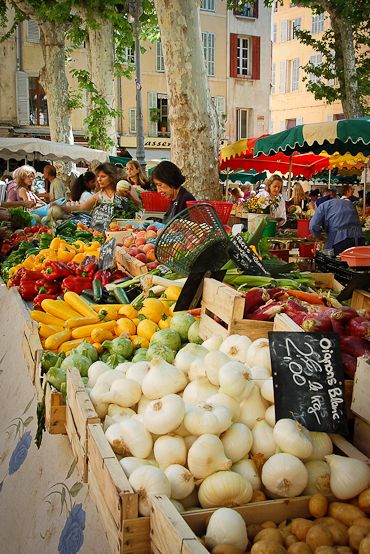Outdoor French market filled with fresh vegetables, key to how to eat like a French woman.