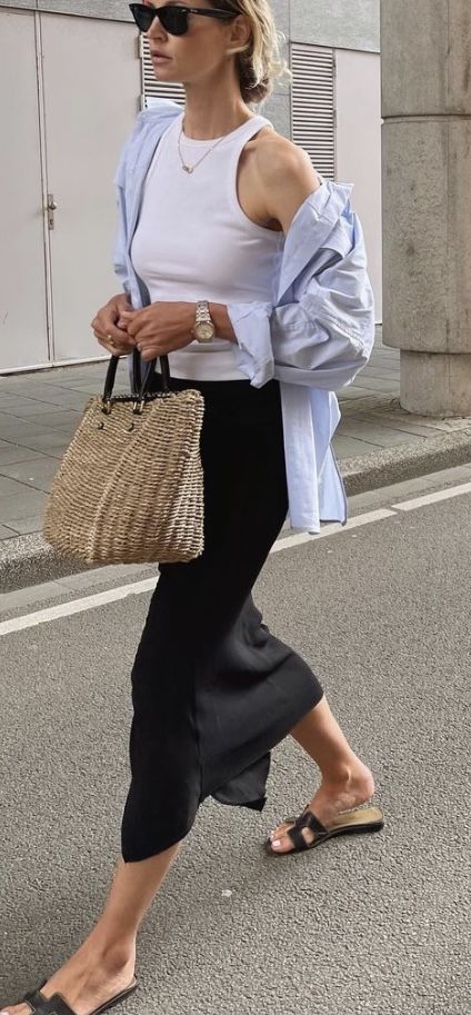 Parisian summer style with a black slip skirt, white tank, and straw tote