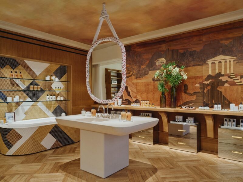 Bright and elegant Diptyque boutique interior in Paris with orchids and marble. french perfume shops in paris
