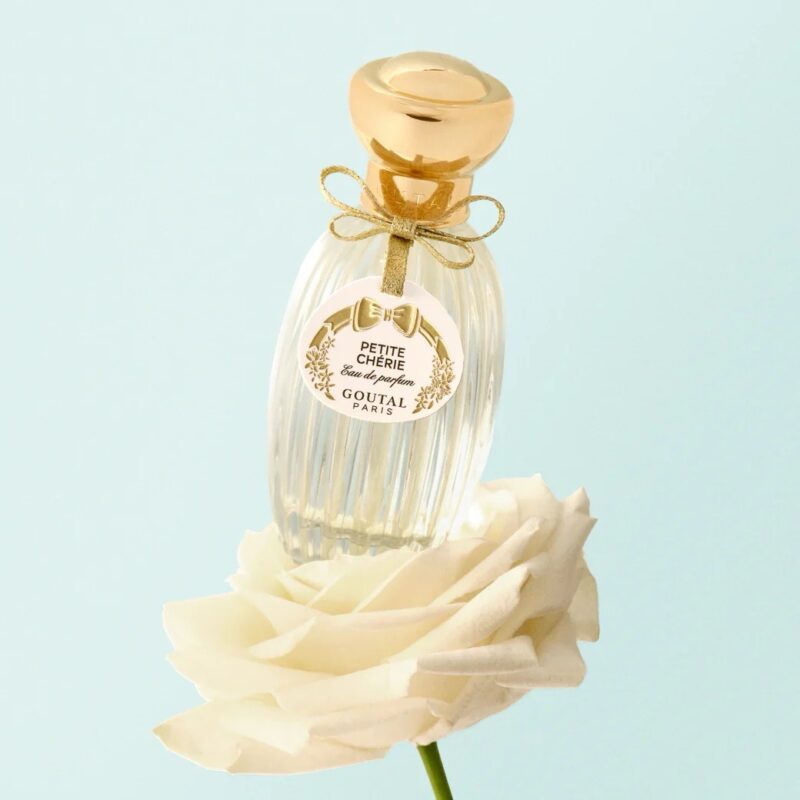 Petite Chérie perfume by Goutal sitting on a white flower
