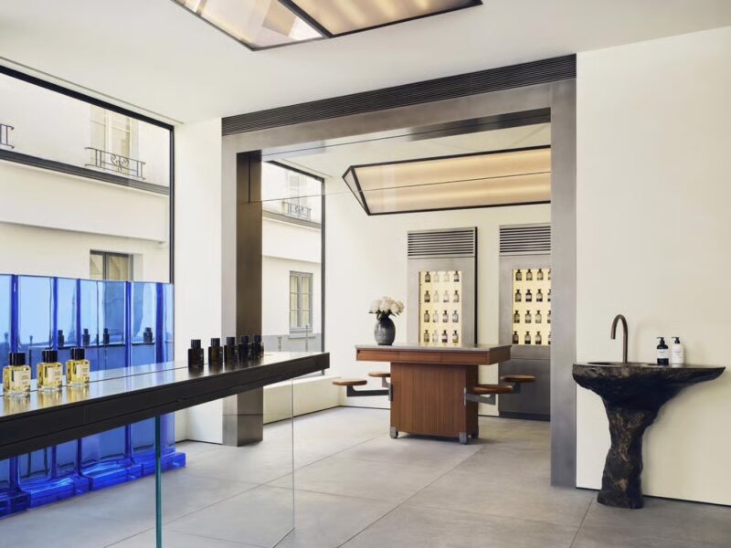 Minimalist perfume shop in Paris with clean lines and blue accent wall at Matière Première. french perfume shops in paris