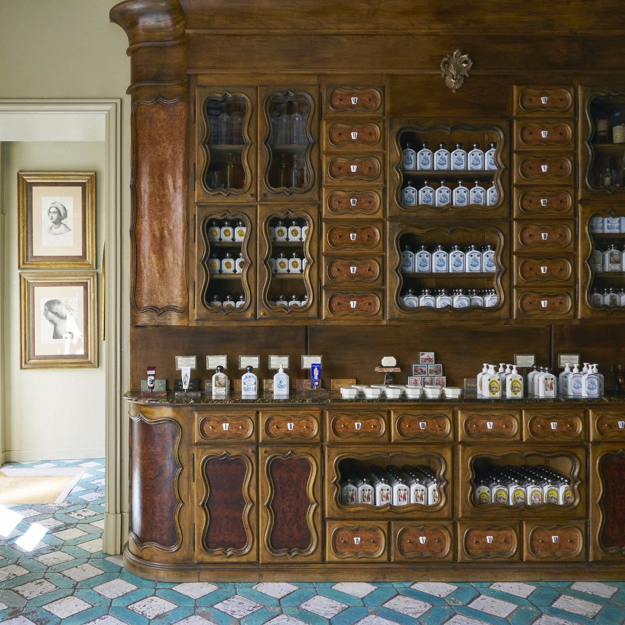 Interior of Officine Universelle Buly, a French perfume shop in Paris with vintage wooden apothecary shelving. french perfume shops in paris