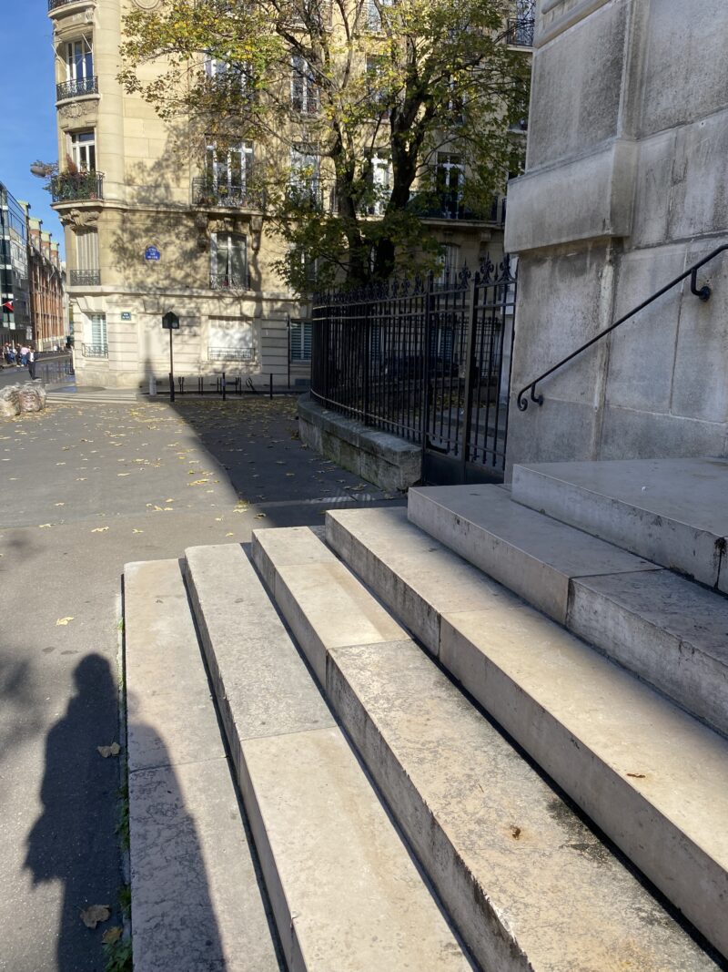 Long shadows on stone steps in Paris during October.