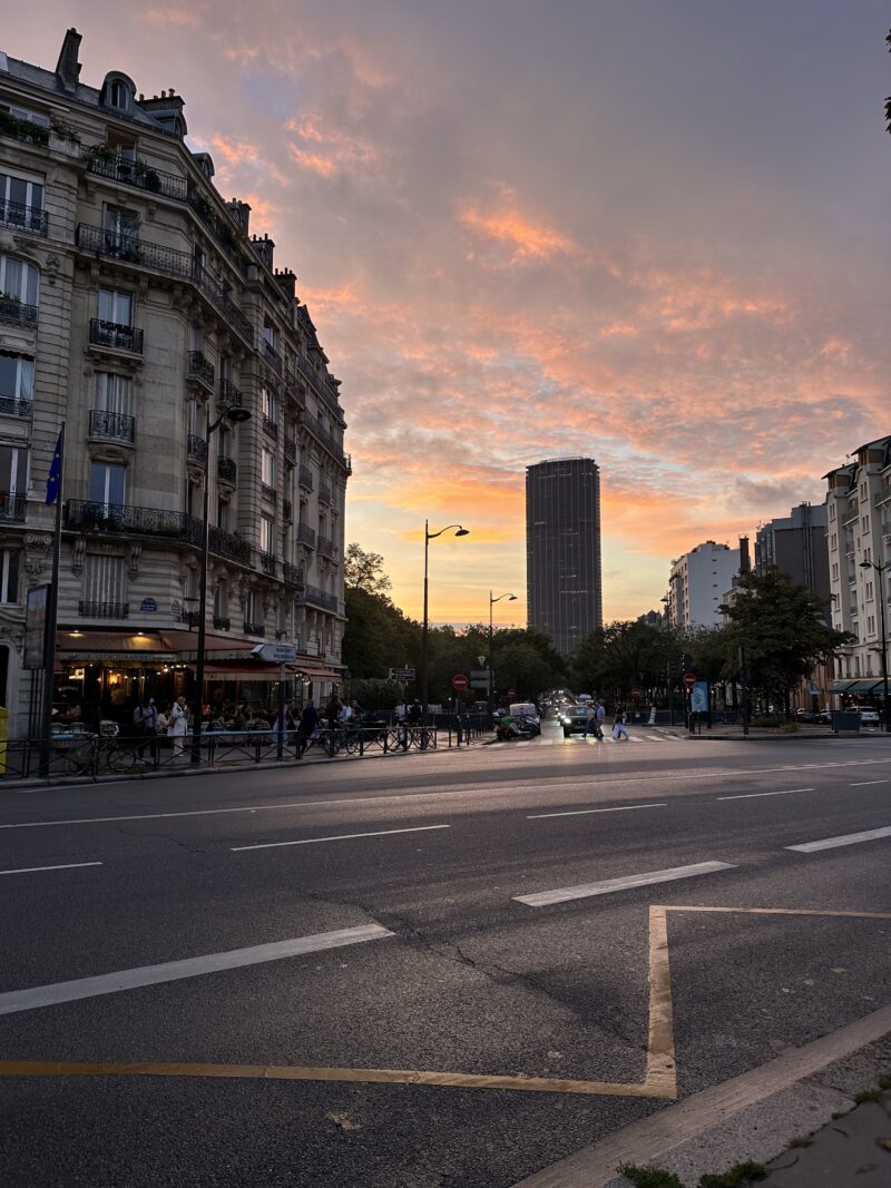 sunset over montparnasse with bustling café in Paris during September