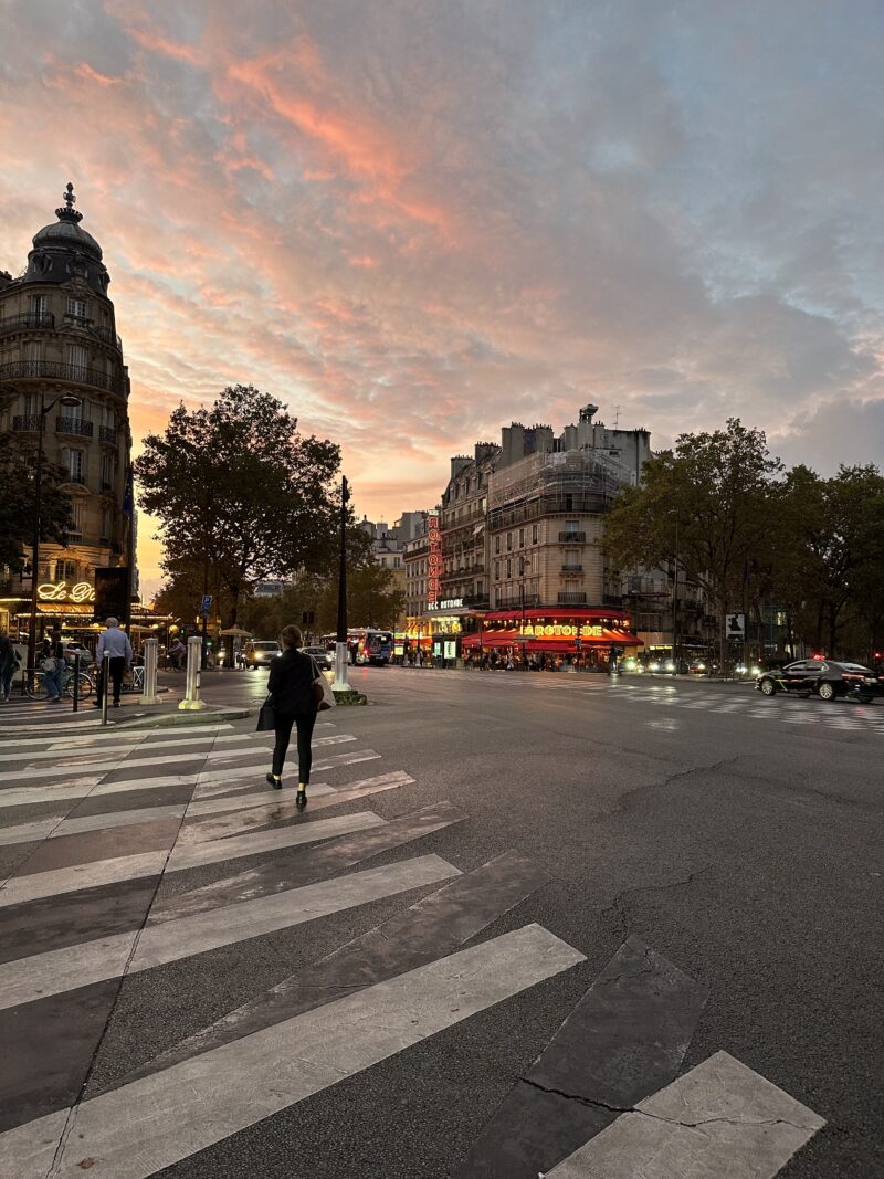 view of la rotonde and classic haussmann buildings at sunset in Paris during September