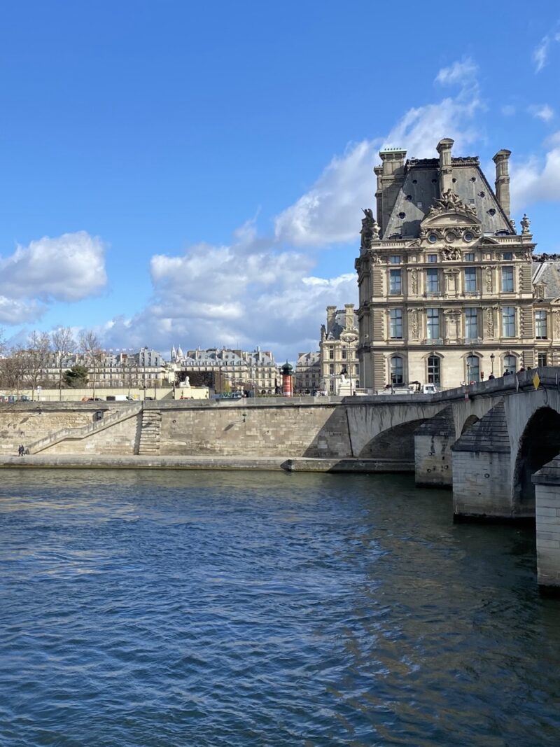 Clear blue sky over the Louvre Museum and the Seine River in Paris during summer
