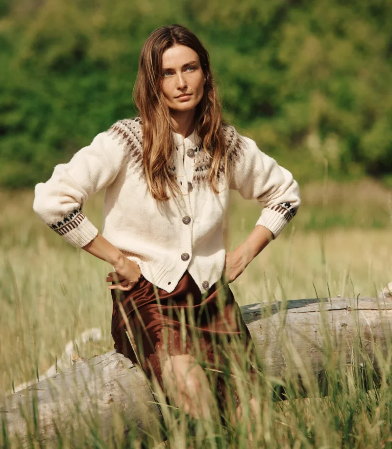 Woman wearing a cream knit cardigan and satin skirt by Dôen, embodying the effortless, romantic style that echoes Sézane’s French aesthetic.