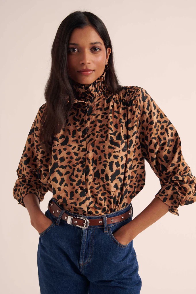 Model wearing Balzac Paris leopard print blouse with high-waisted jeans