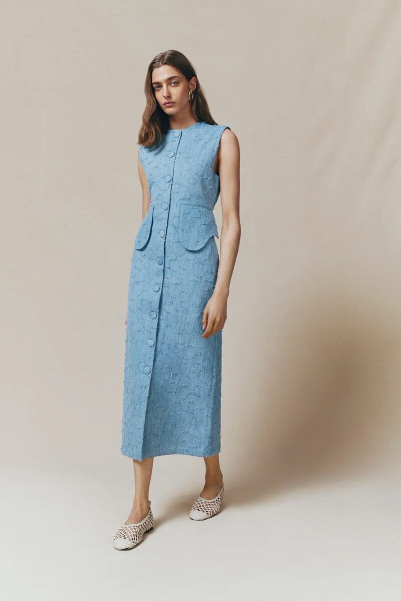 Model wearing sculptural sleeveless blue dress by Destrée, one of the brands like Sézane