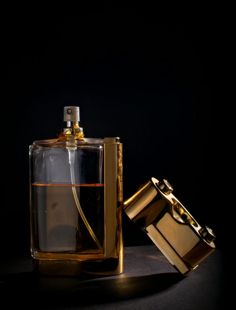 A modern perfume bottle on a black background, reflecting the contemporary chapter in the history of perfume.