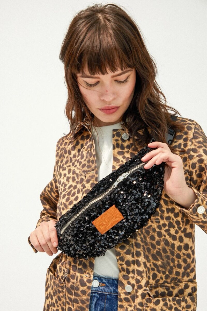 Close-up of a sequin belt bag from Make My Lemonade paired with a leopard jacket