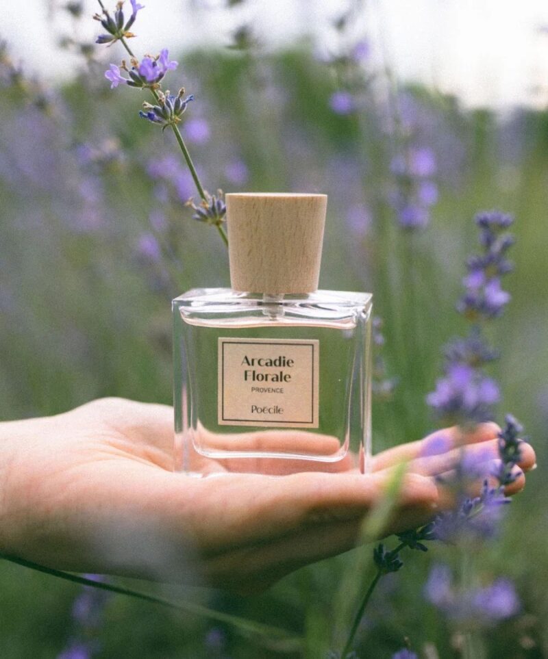 Bottle of Poécile Arcadie Florale perfume held in a lavender field – a clean, French non-toxic perfume from Provence