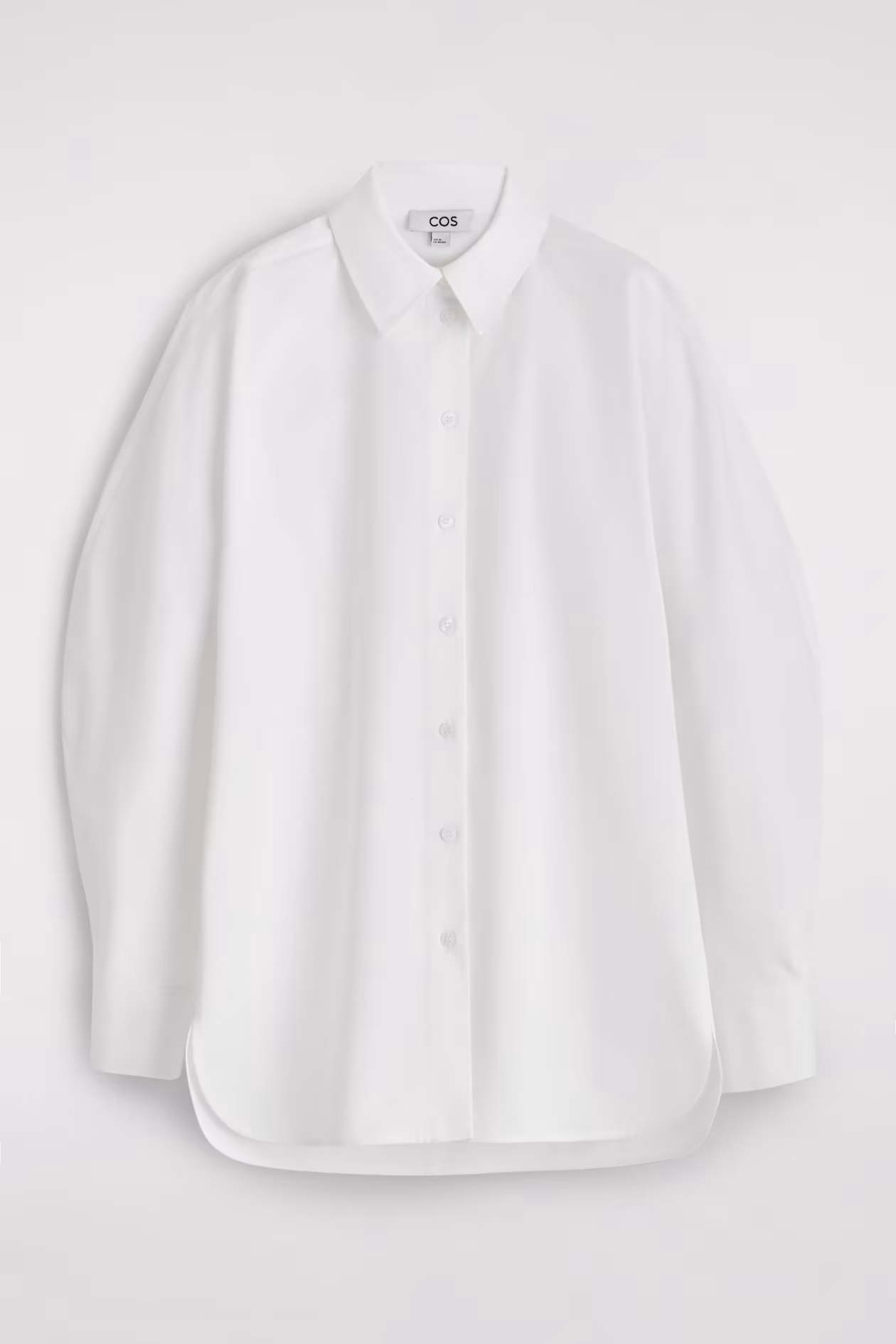 parisian style crisp white shirt by the brand COS one of 10 Parisian Style Staples You Can Add to Your Closet Right Now