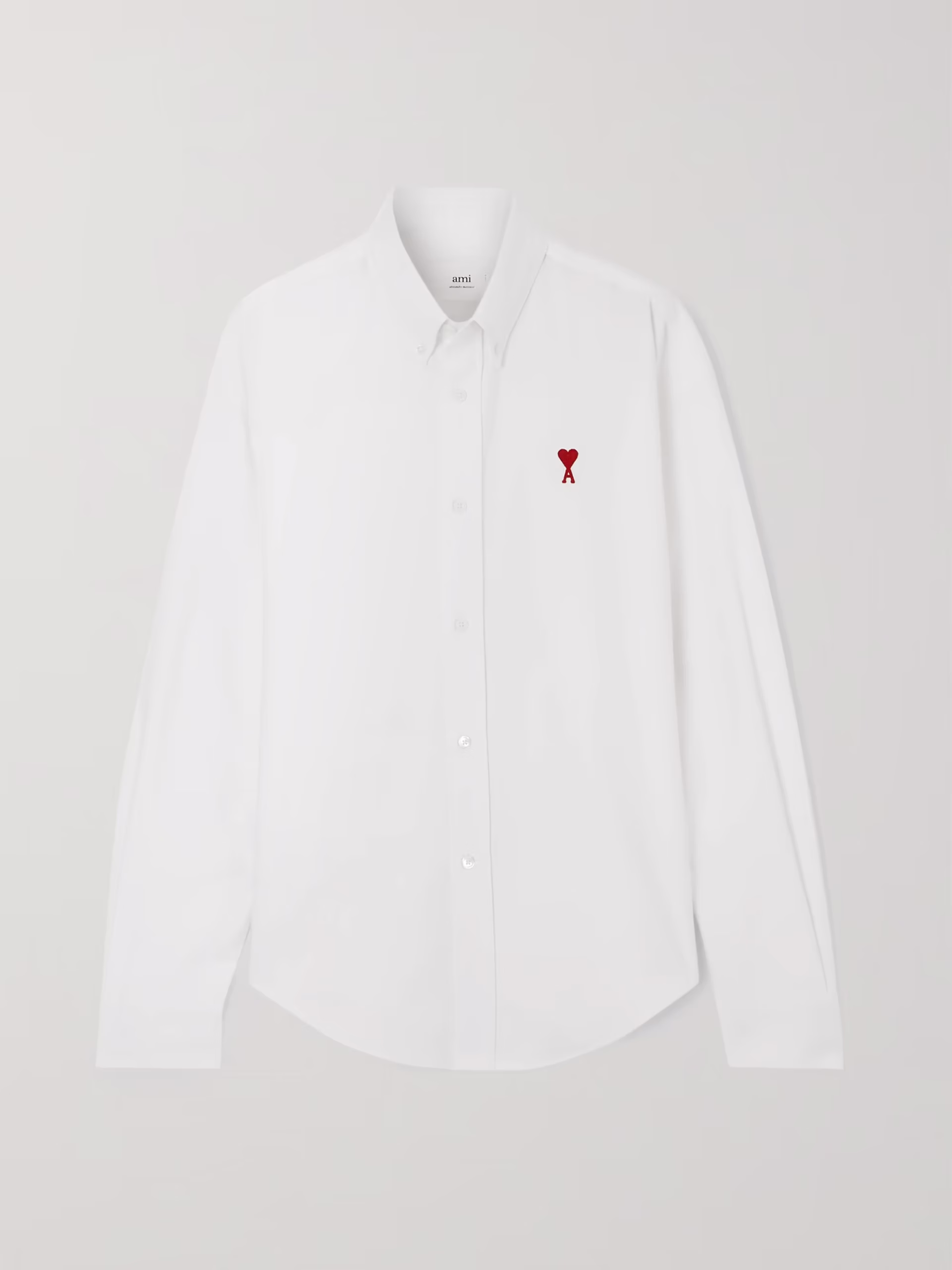 parisian style crisp white shirt by the brand AMI Paris one of 10 Parisian Style Staples You Can Add to Your Closet Right Now