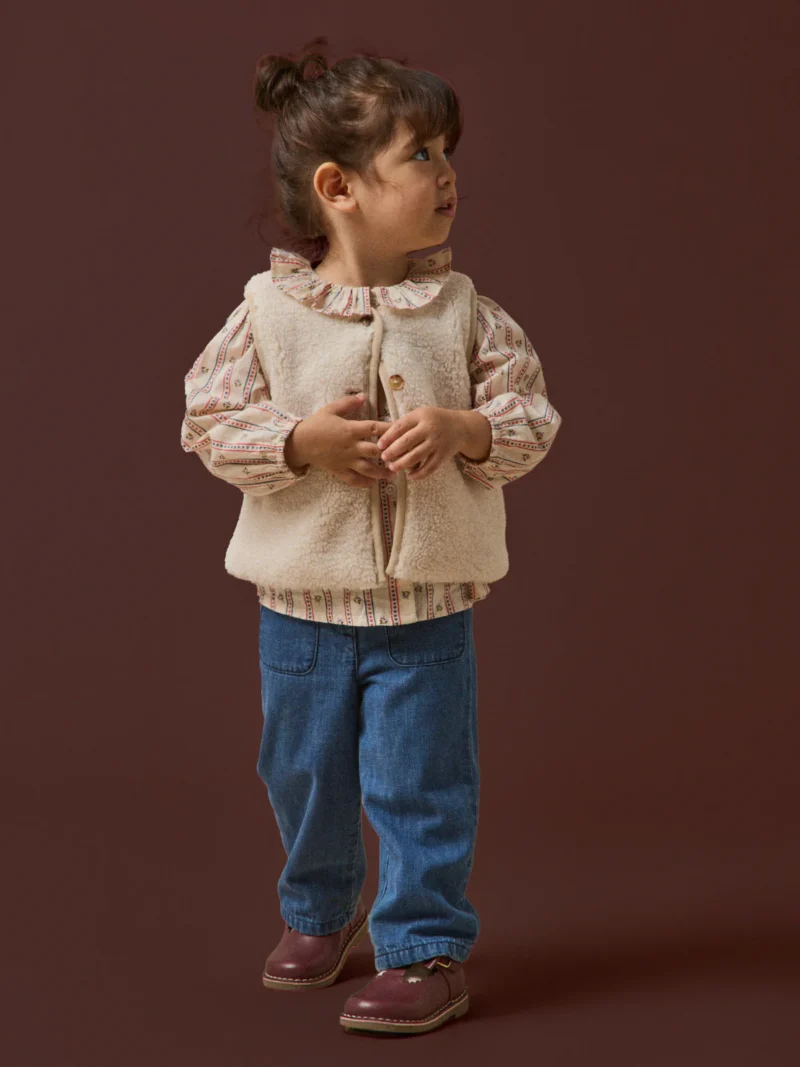 Toddler in a layered winter outfit from Cyrillus, a French baby clothing brand.
