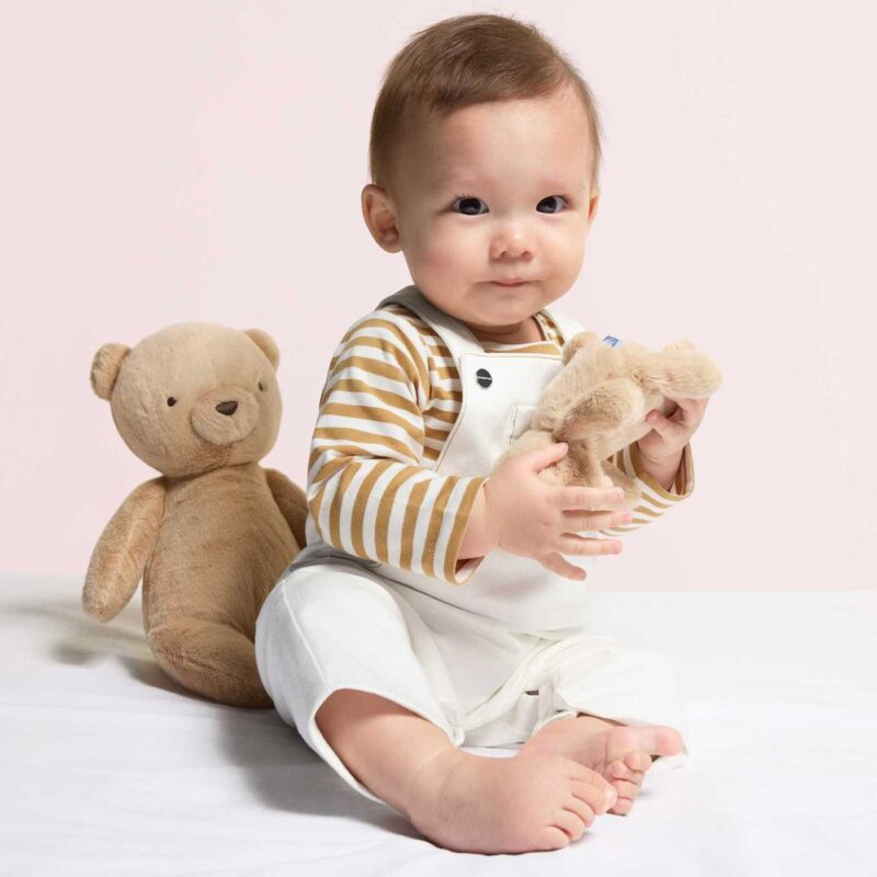 Baby in a striped romper from Jacadi, one of the most iconic French baby clothing brands.