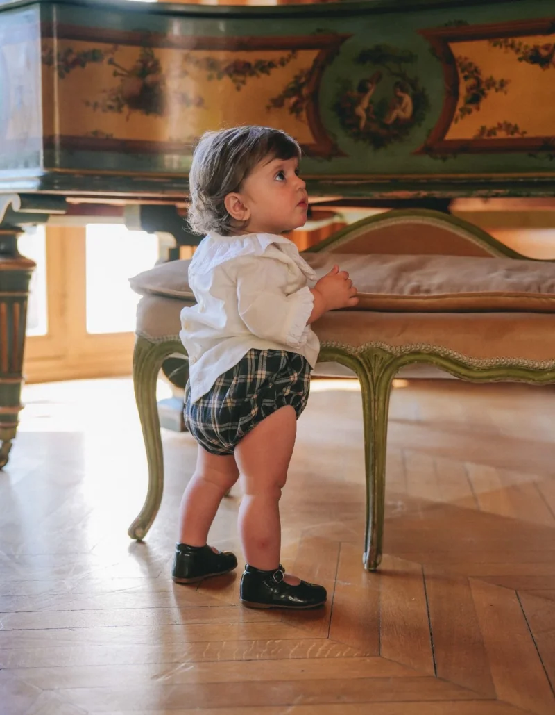 Baby wearing a chic outfit from Loir Paris, a French baby clothing brand.