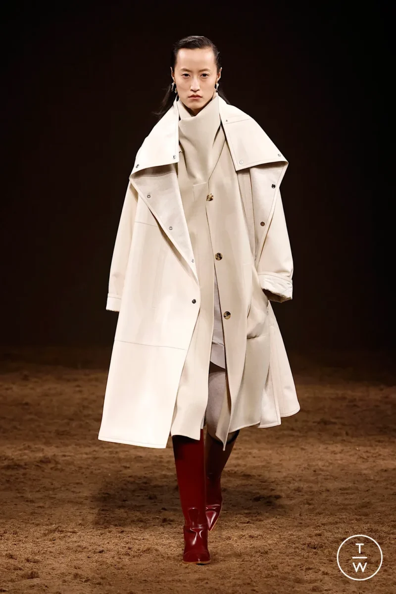 Model in a cream Hermès trench coat, an elegant option for what to wear in Paris in the rain.