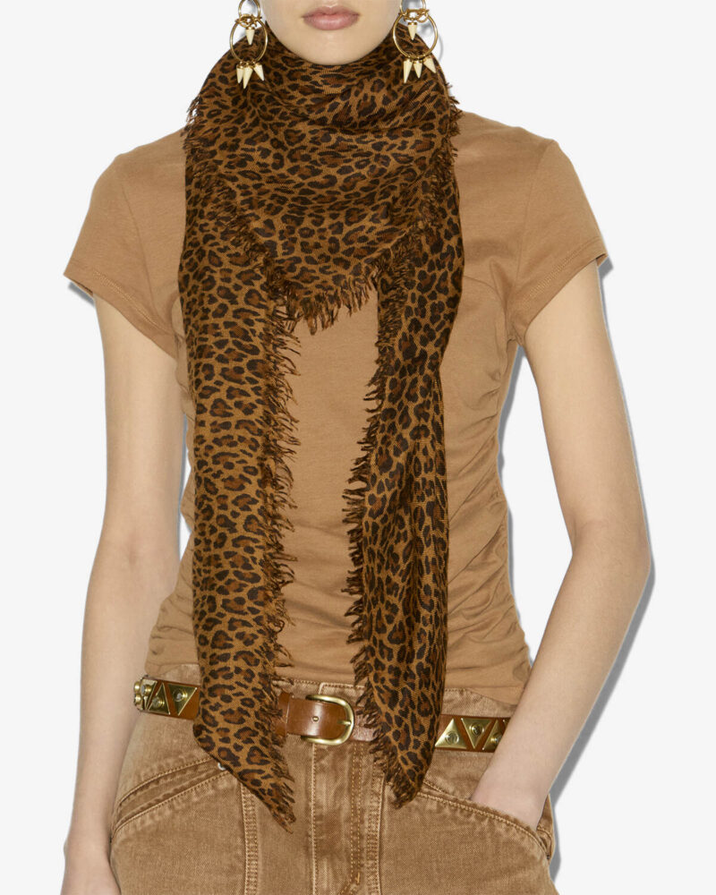 Model wearing a French scarf by Isabel Marant, leopard print wool scarf styled with a brown tee and gold jewelry.