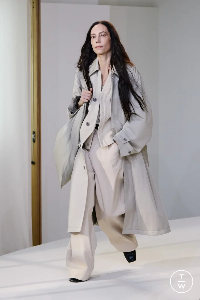 Model in a minimalist Lemaire coat, understated inspiration for what to wear in Paris in the rain.