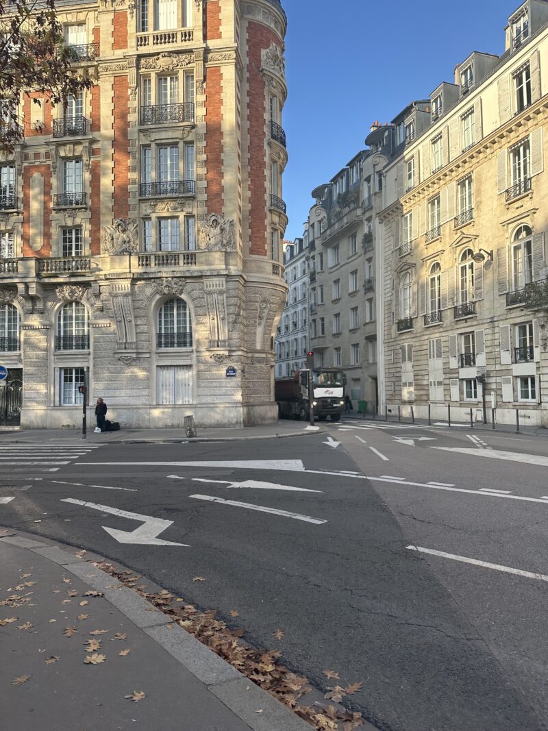 Haussmannian red-brick corner building under November light in Paris