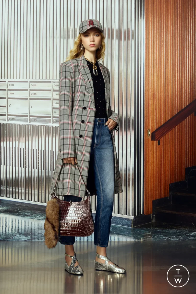 Rabanne runway model wearing cropped jeans styled with a tailored coat, a modern Parisian denim look.