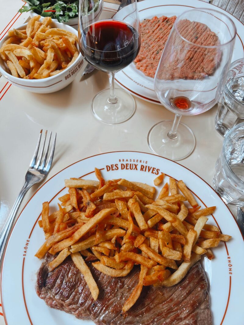 Steak-frites served with red wine at a Parisian bistro