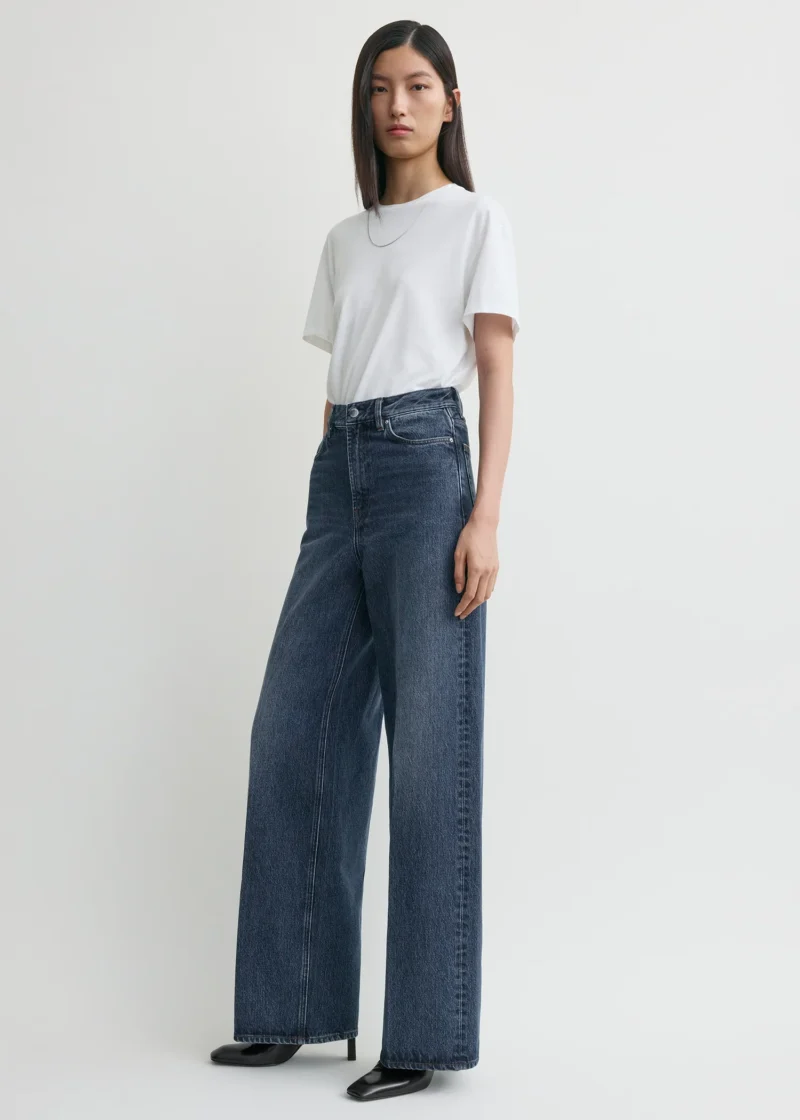 Model wearing wide-leg Totême jeans from the FW25 collection, a Parisian style denim essential.