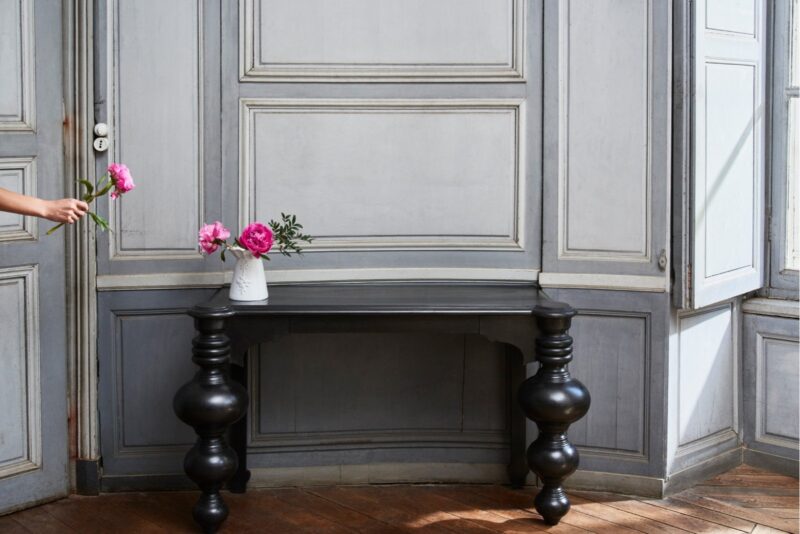 What to buy in Paris: Astier de Villatte white ceramic vase with pink peonies on a black console