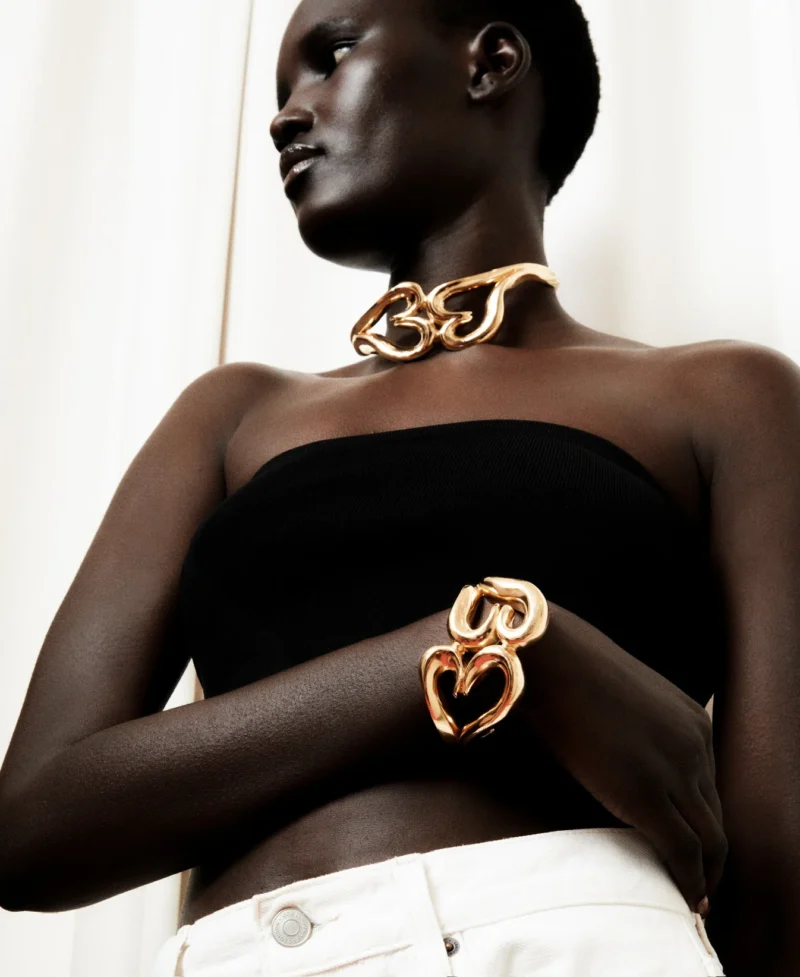 Model wearing bold statement jewelry handcrafted by Annelise Michelson in Paris.