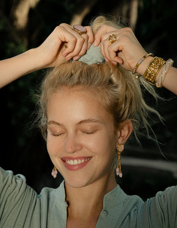 Model wearing gold jewelry by Aurélie Bidermann