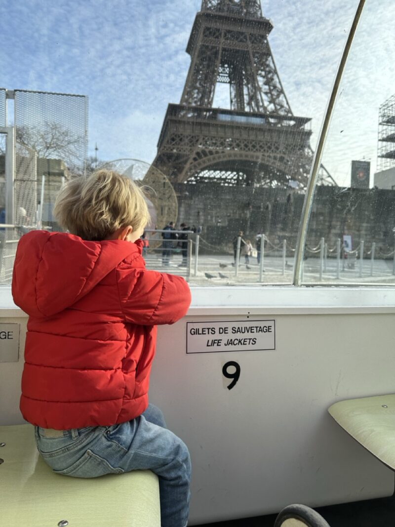 toddler on a boat near the Eiffel Tower