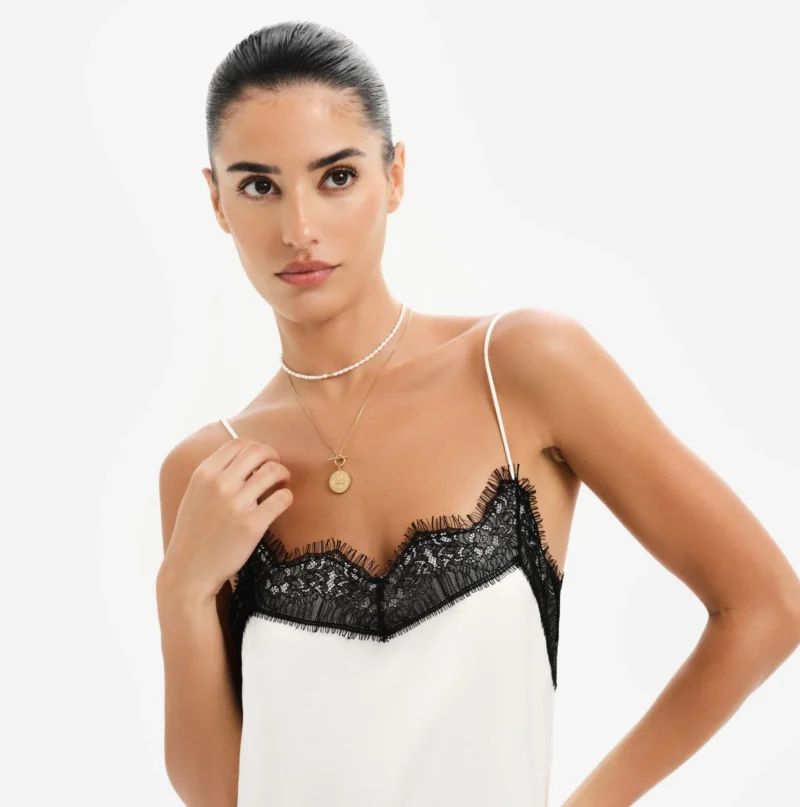 Woman wearing layered necklaces by Bruna