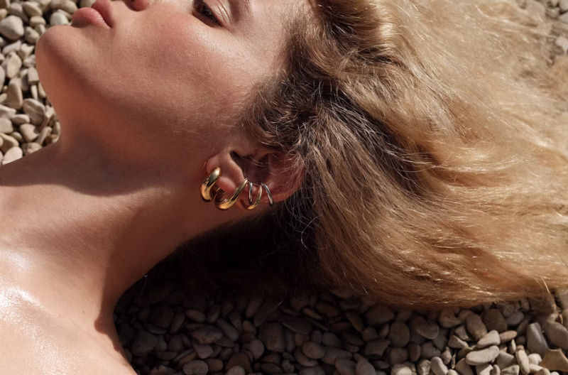 Fluid gold hoops designed by Charlotte Chesnais in her Paris atelier.