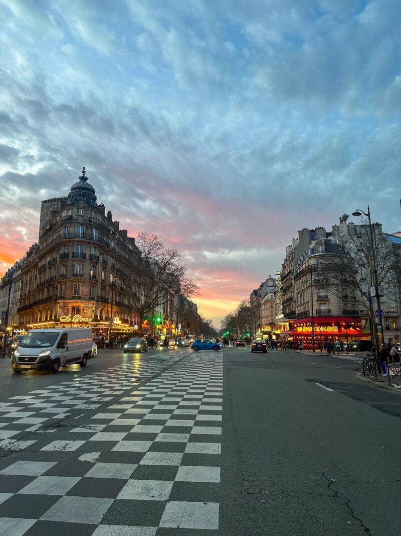 Paris boulevard at sunset with winter light and Haussmann buildings in December.