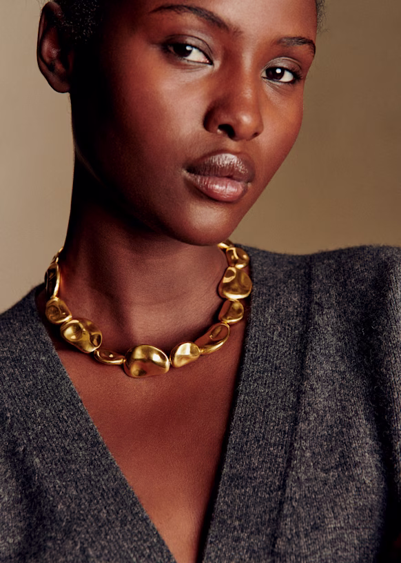 Sézane model wearing a statement gold necklace