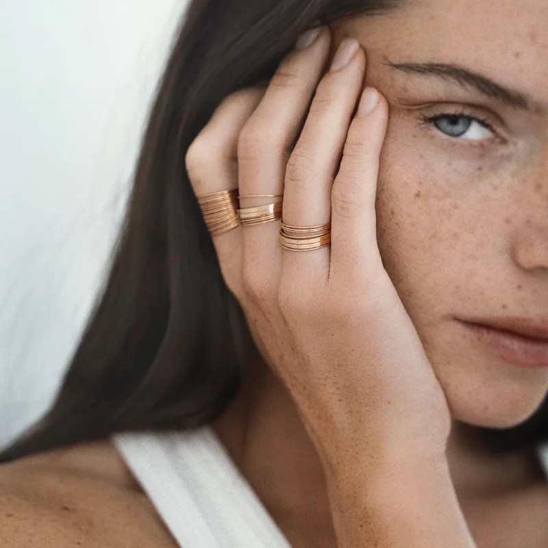 Minimal gold jewelry by Vanrycke, known for understated Parisian elegance.