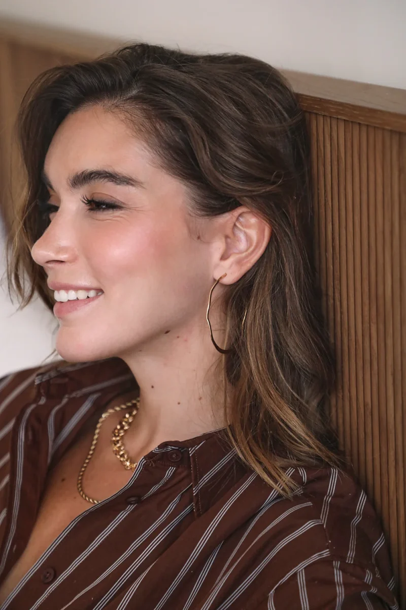 Model wearing Waekura gold hoops